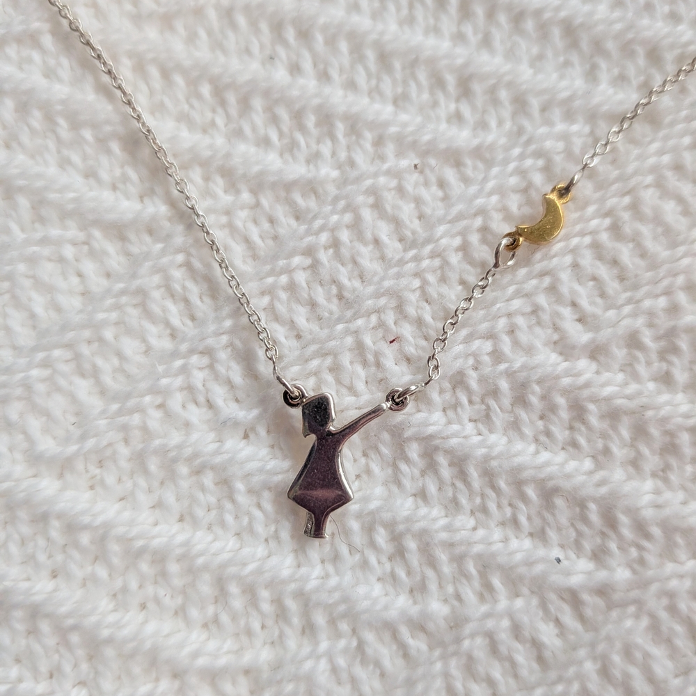 Silver Figure Pendant Necklace with Gold Accent
